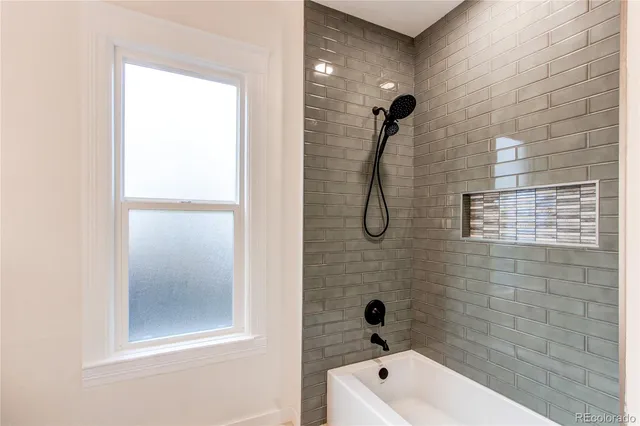 a bathroom with a bath tub and a shower