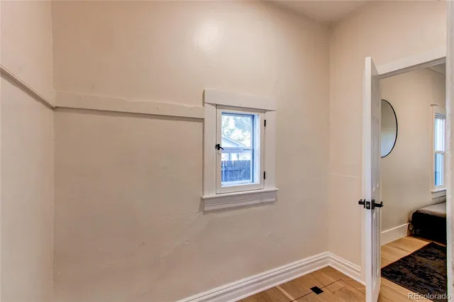 a room with a window and a mirror