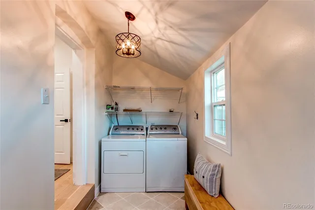 a kitchen with a stove and a chandelier