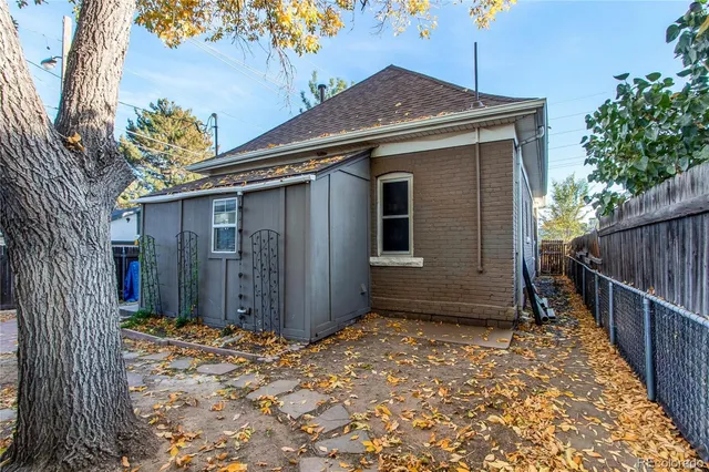 a view of a house with wooden fence