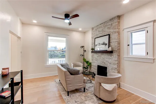 a living room with furniture and a fireplace