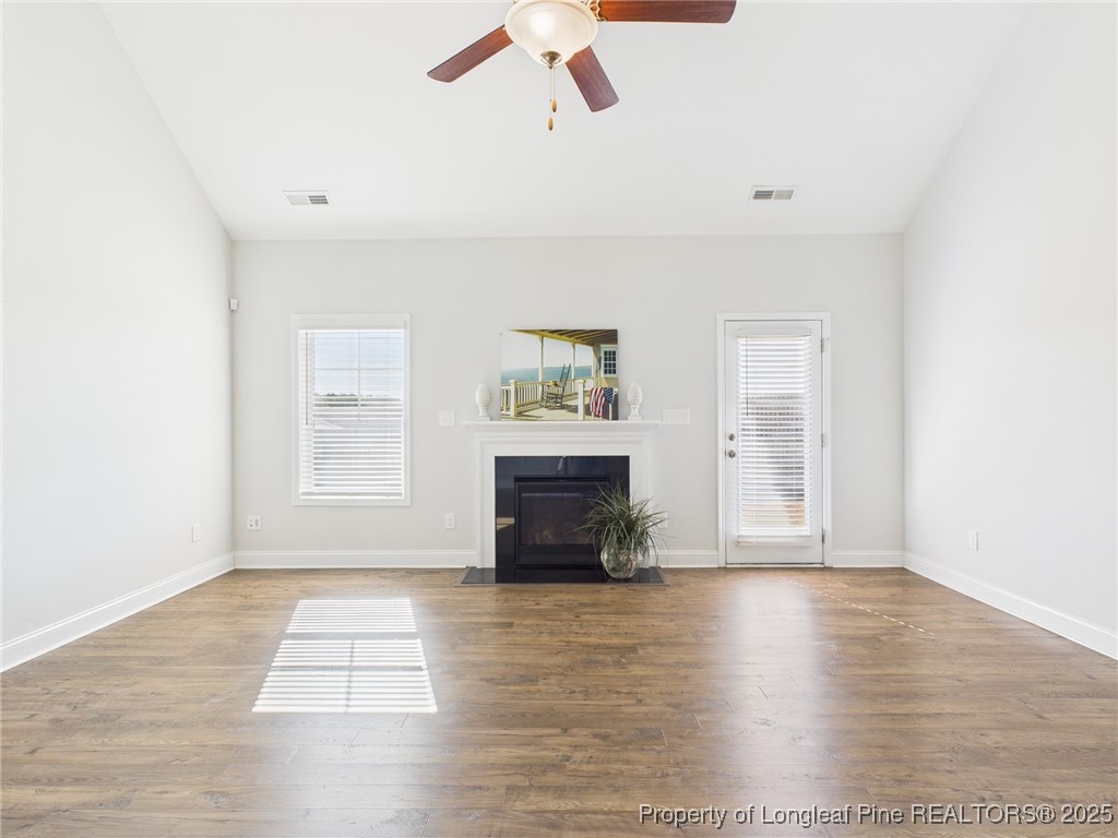 3149 Hunting Lodge Road Fayetteville, NC 28306 - Photo 12 of 49 an empty room with windows and fireplace