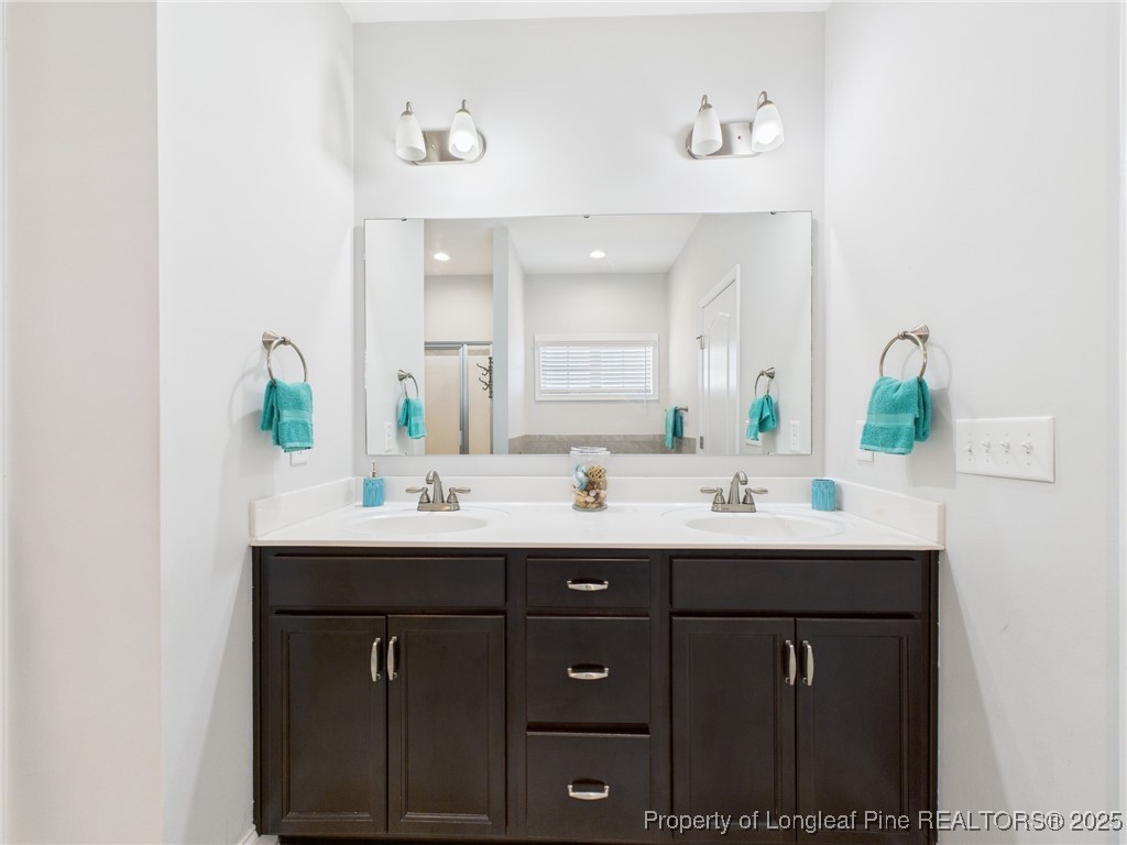 3149 Hunting Lodge Road Fayetteville, NC 28306 - Photo 20 of 49 a bathroom with a sink and a mirror