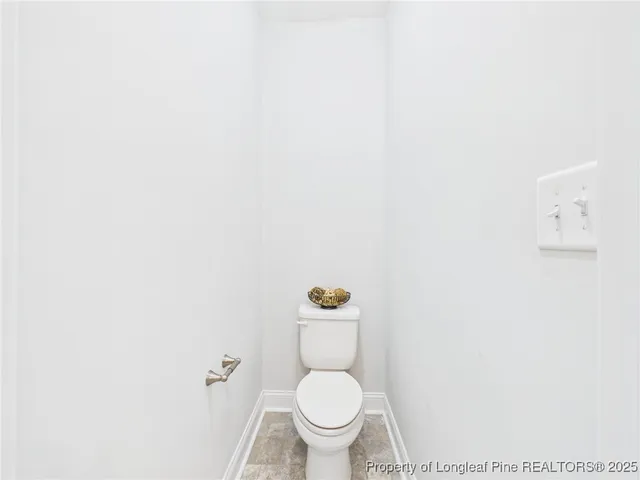 a bathroom with a shower curtain and a toilet