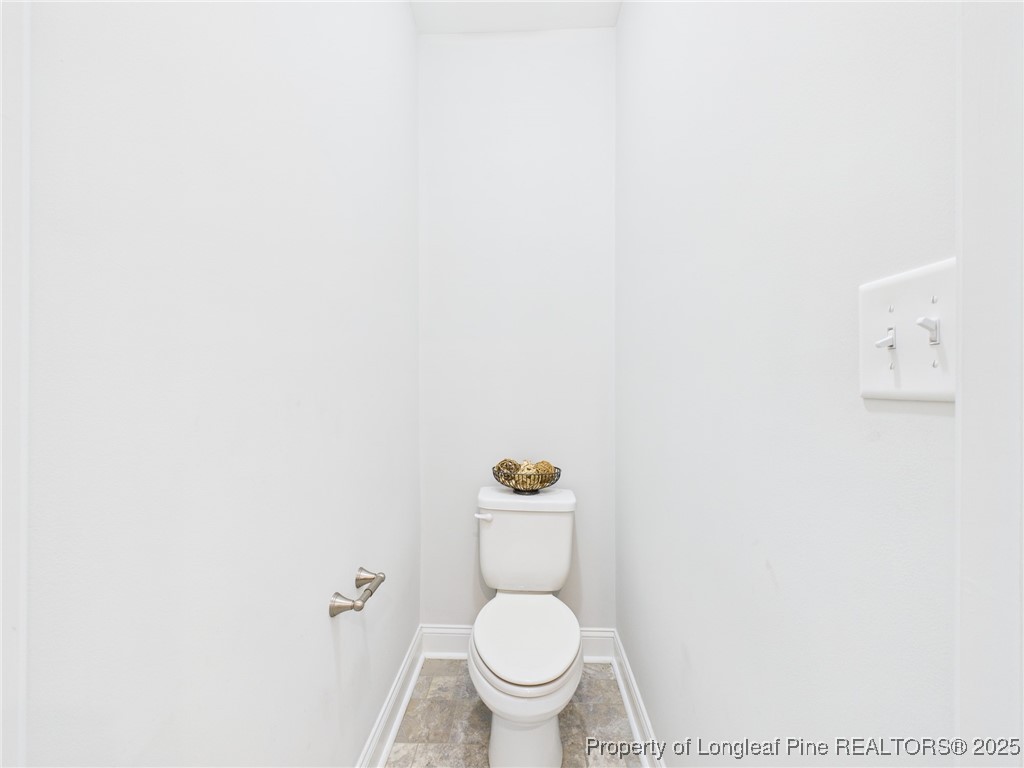 3149 Hunting Lodge Road Fayetteville, NC 28306 - Photo 23 of 49 a white toilet sitting next to a white wall