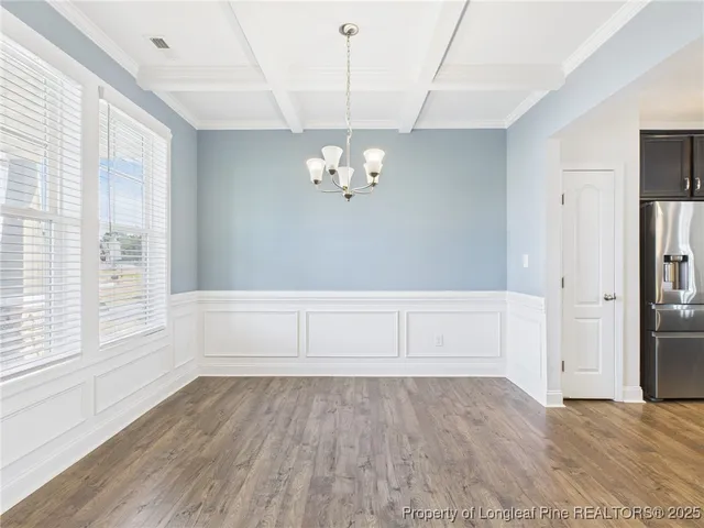 a kitchen with stainless steel appliances kitchen island granite countertop a sink dishwasher a stove and a refrigerator