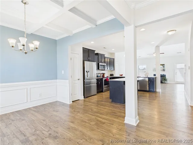 a kitchen with stainless steel appliances granite countertop a sink refrigerator and cabinets