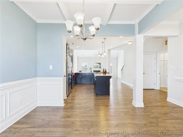 a large kitchen with stainless steel appliances kitchen island granite countertop a sink a counter space and cabinets