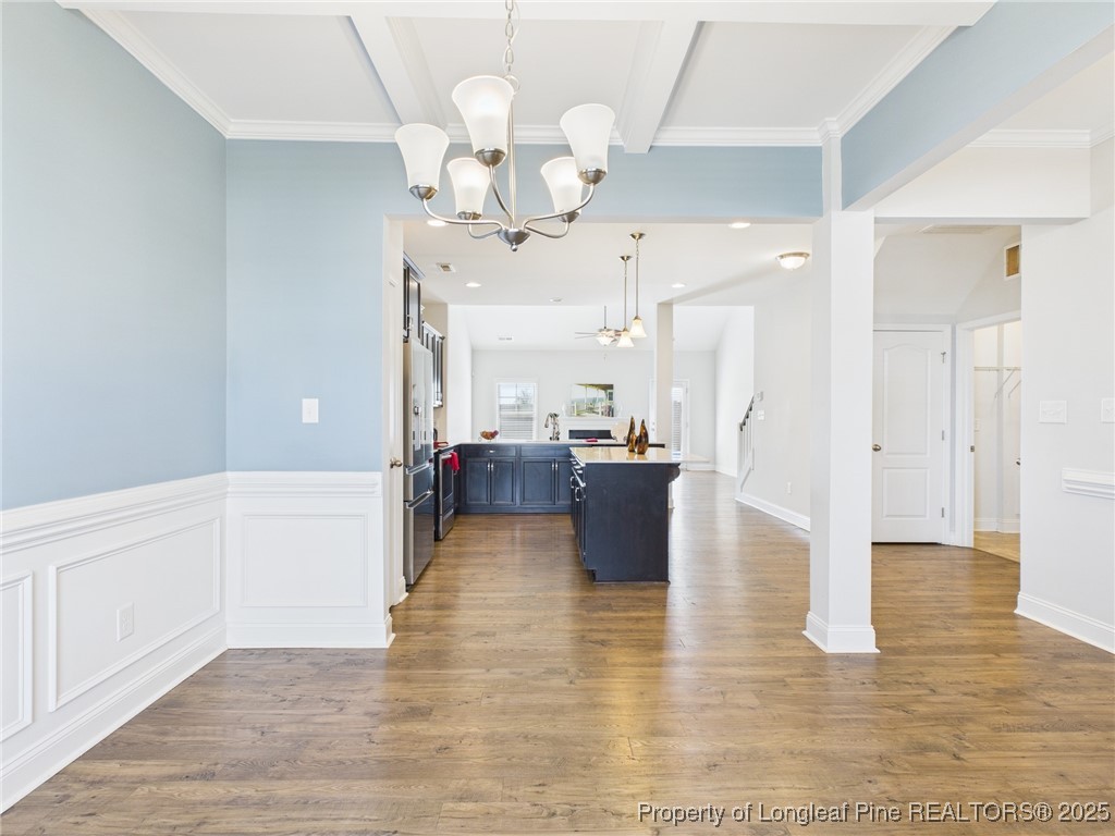 3149 Hunting Lodge Road Fayetteville, NC 28306 - Photo 5 of 49 a large white kitchen with a large island oven a stove and a chandelier