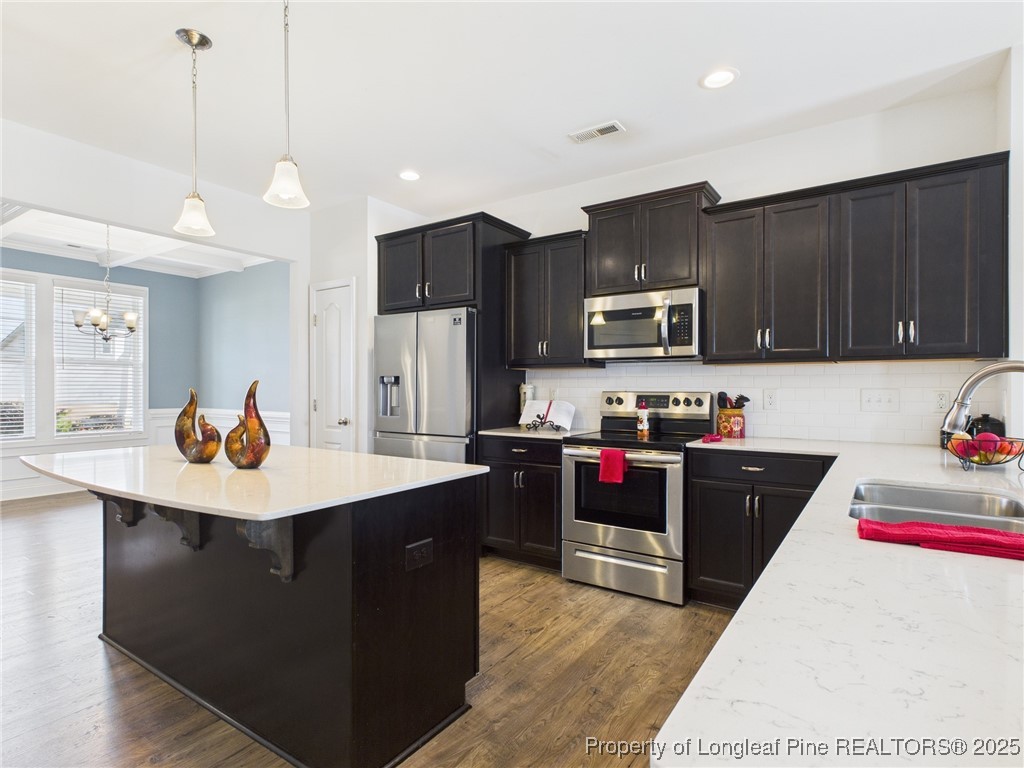 3149 Hunting Lodge Road Fayetteville, NC 28306 - Photo 7 of 49 a kitchen with stainless steel appliances kitchen island granite countertop a sink dishwasher a stove and a refrigerator