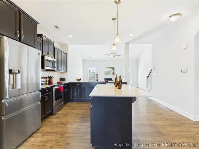 an empty room with a ceiling fan and a window