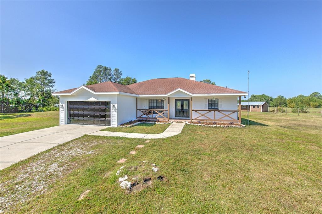 7509 Hackamore Road Zephyrhills, FL 33541 - Photo 1 of 1 a front view of a house with swimming pool