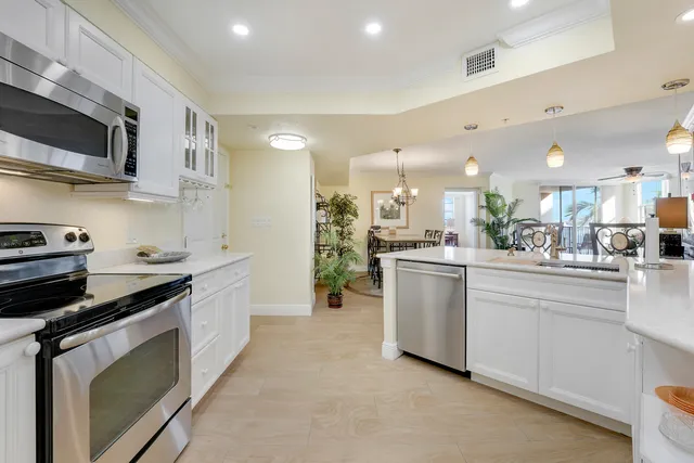 a kitchen with white cabinets and appliances
