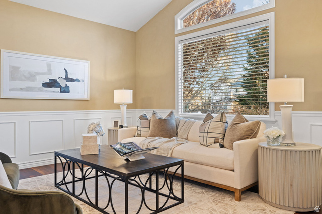 6208 West Bull River Road Highland, UT 84003 - Photo 6 of 90 Living area featuring a vaulted ceiling and an expansive window with an arched transom