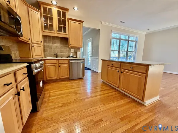 a view of a living room a stove a wooden floor and windows