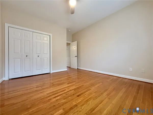 a view of an empty room and wooden floor