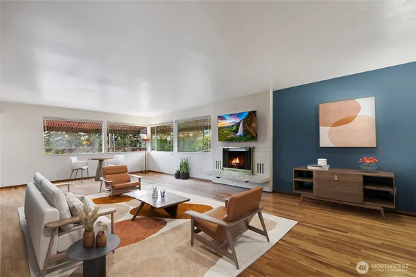 a living room with furniture a rug and a flat screen tv