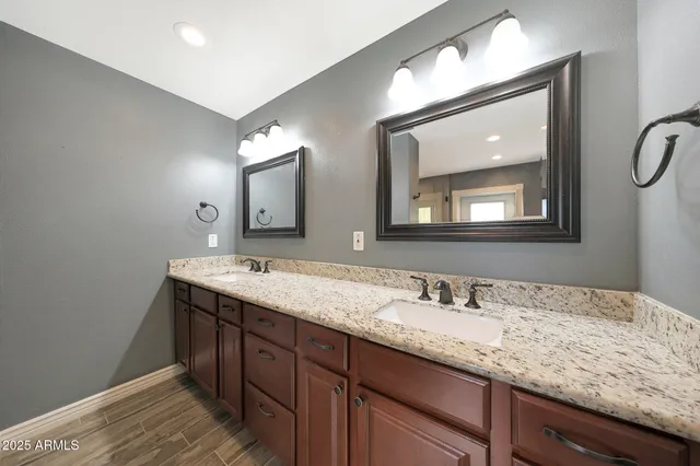 a bathroom with a double vanity sink and a mirror