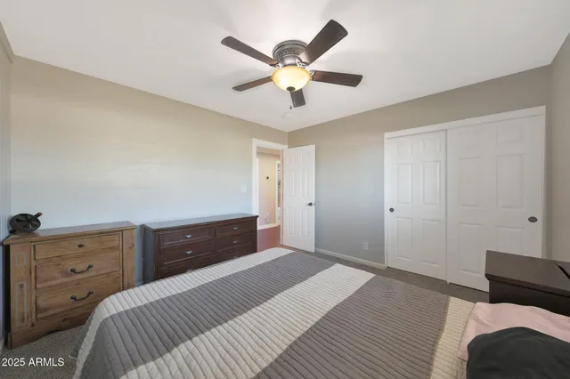 a bedroom with a bed and a dresser