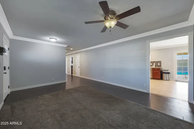 an empty room with fan and entrance