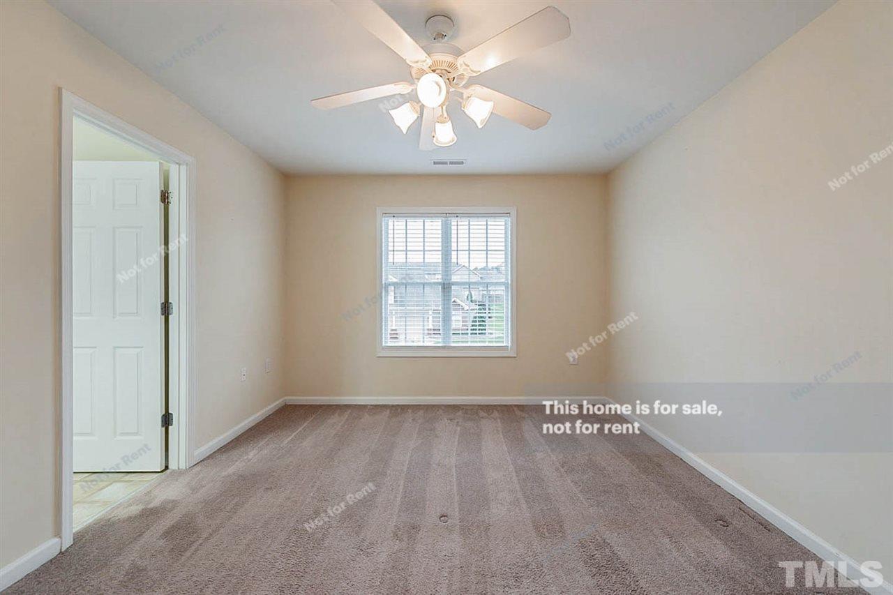 2608 Andover Glen Road Raleigh, NC 27604 - Photo 12 of 19 a view of an empty room with window and a chandelier fan