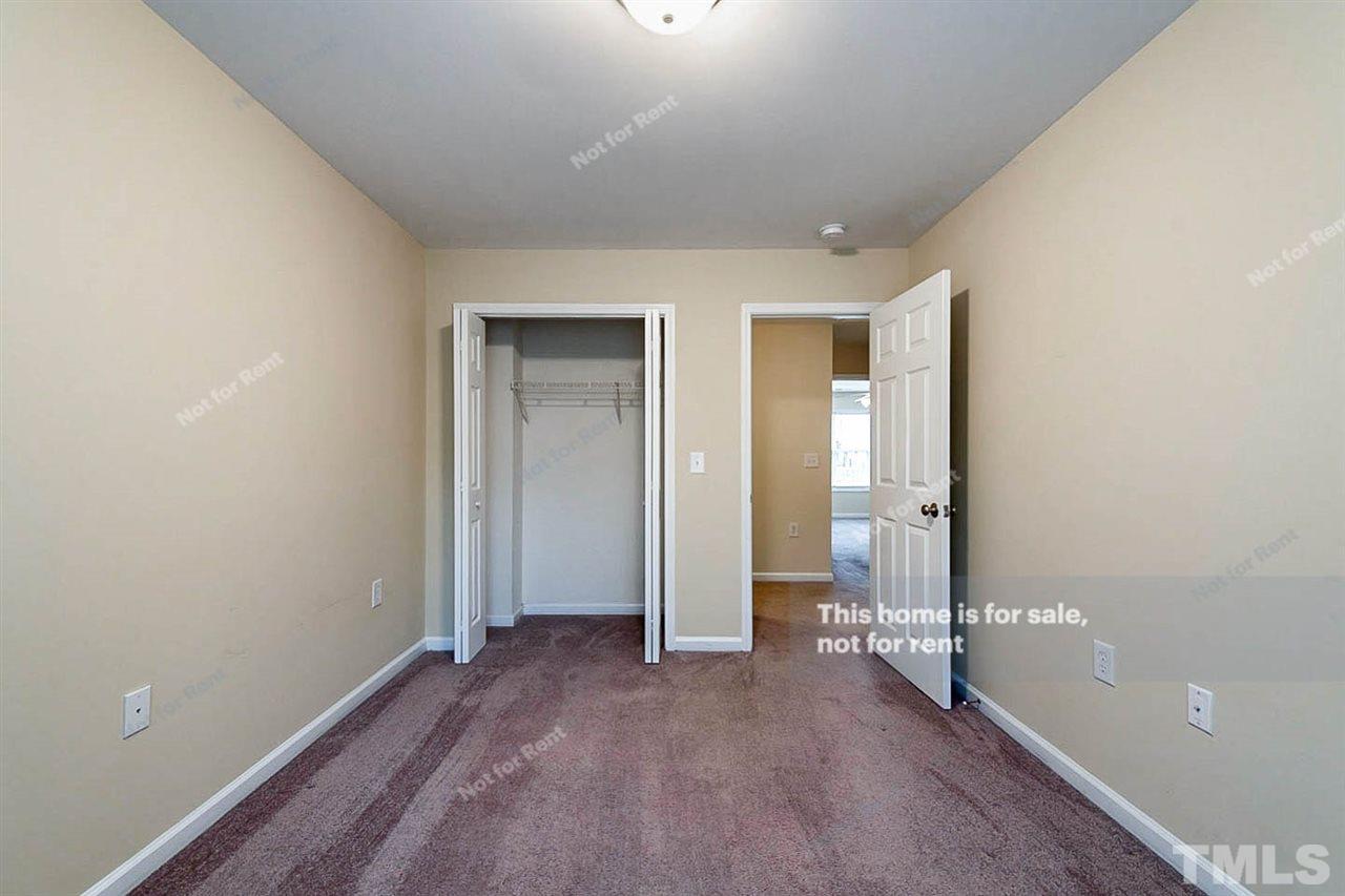 2608 Andover Glen Road Raleigh, NC 27604 - Photo 15 of 19 an empty room with closet and wooden door