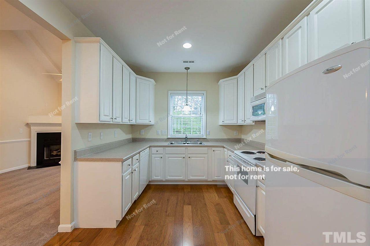2608 Andover Glen Road Raleigh, NC 27604 - Photo 4 of 19 a kitchen with a sink a stove and cabinets