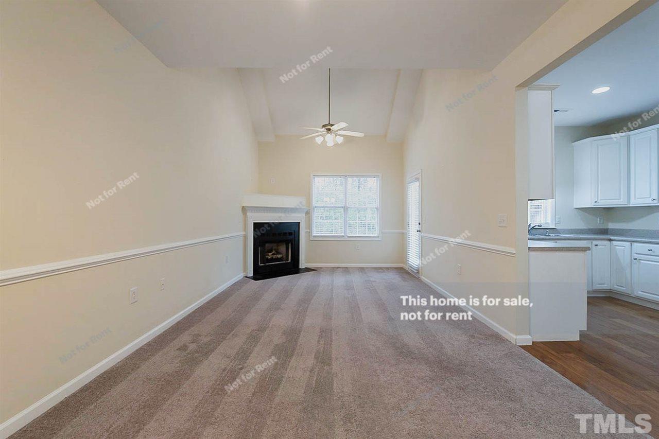 2608 Andover Glen Road Raleigh, NC 27604 - Photo 5 of 19 a view of empty room with kitchen and fireplace