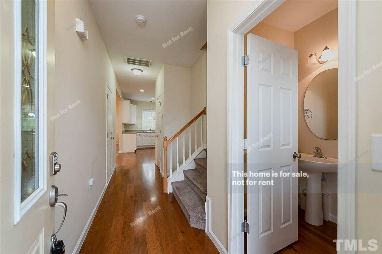 2608 Andover Glen Road Raleigh, NC 27604 - Photo 8 of 19 a view of a hallway with wooden floor and staircase