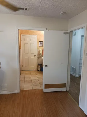 a view of room with wooden floor and ceiling fan