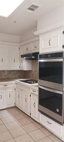 a view of a kitchen with electric appliances