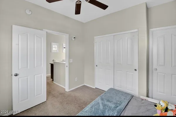 a bedroom with a large bed and a window