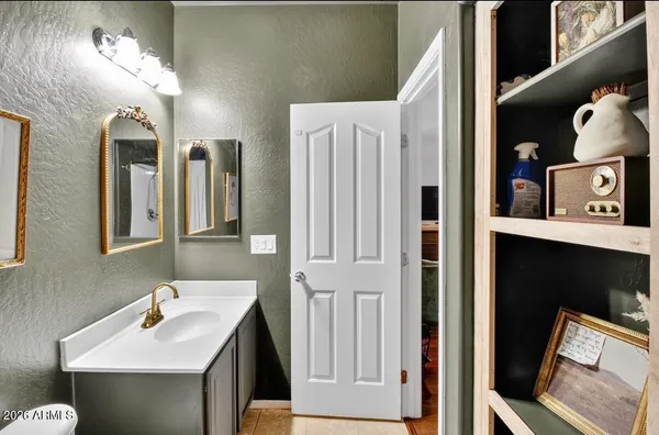 a bathroom with a sink vanity and a mirror