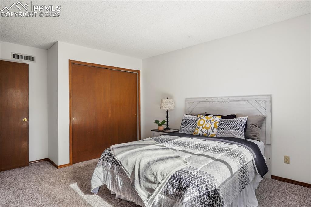6385 Bismark Road Colorado Springs, CO 80922 - Photo 13 of 25 a bedroom with a bed and a window
