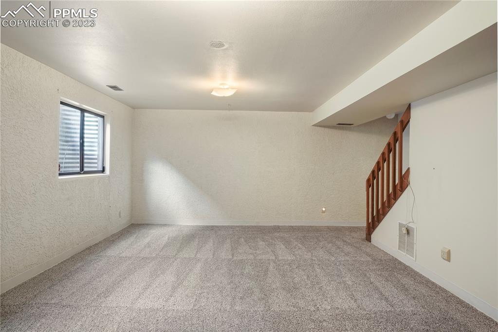 6385 Bismark Road Colorado Springs, CO 80922 - Photo 15 of 25 a view of an empty room with stairs