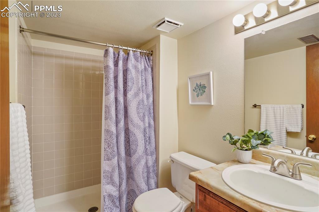 6385 Bismark Road Colorado Springs, CO 80922 - Photo 17 of 25 a bathroom with a sink toilet and shower