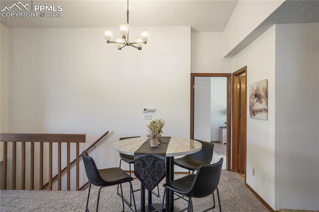 6385 Bismark Road Colorado Springs, CO 80922 - Photo 7 of 25 a view of a dining room with furniture and wooden floor