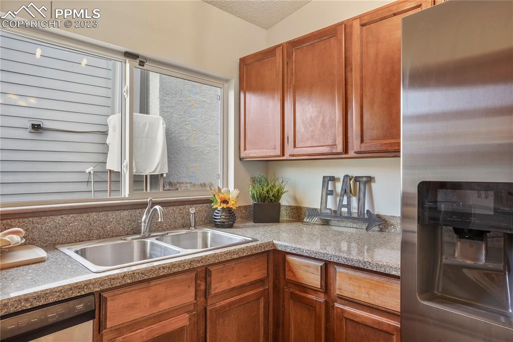 6385 Bismark Road Colorado Springs, CO 80922 - Photo 9 of 25 a kitchen with granite countertop a sink and cabinets