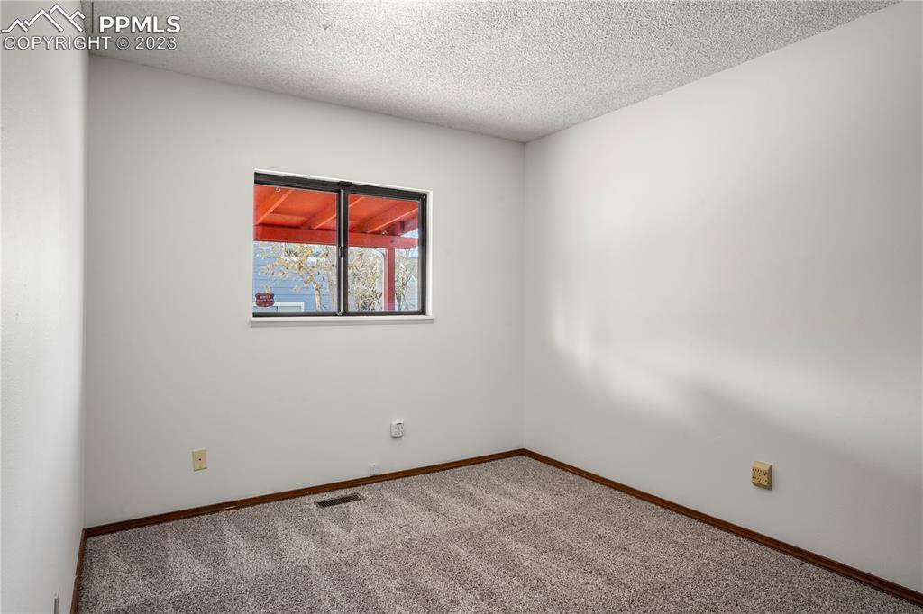6385 Bismark Road Colorado Springs, CO 80922 - Photo 10 of 25 an empty room with a window