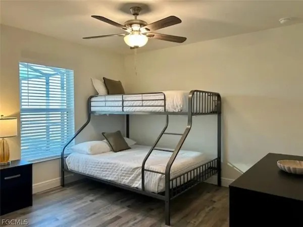 a bathroom with a granite countertop sink toilet and mirror