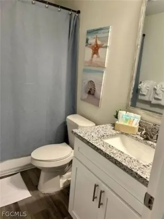 a bedroom with a bed a rug a lamp and a window