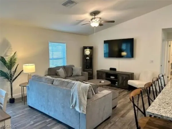 a kitchen with a refrigerator and a stove top oven