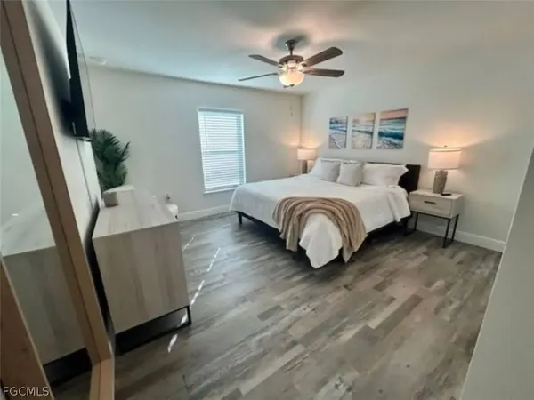 a bedroom with a bed and lamps