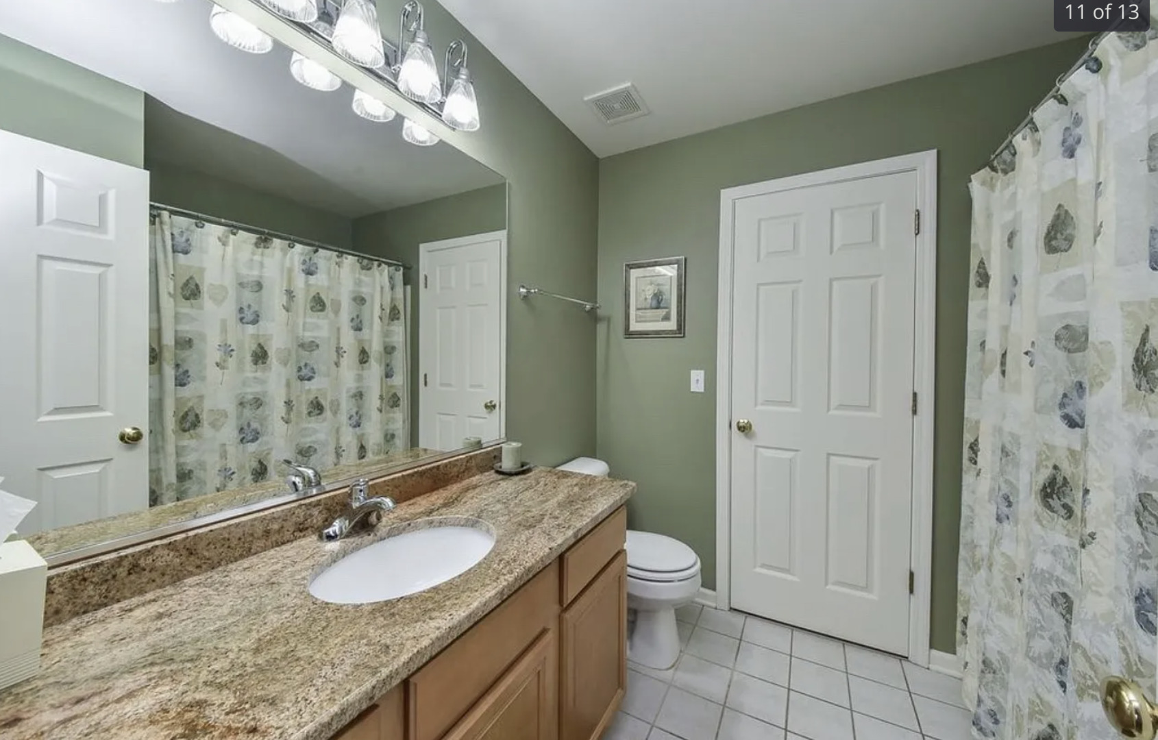2221 Sunrise Circle, Unit 2221 Aurora, IL 60503 - Photo 13 of 15 a bathroom with a granite countertop sink a toilet and shower
