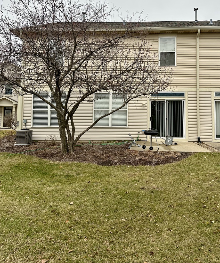 2221 Sunrise Circle, Unit 2221 Aurora, IL 60503 - Photo 15 of 15 a view of a house with a yard