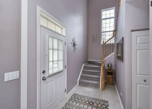 a view of entryway with furniture and windows