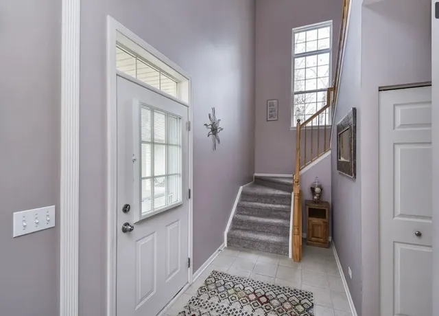 a view of entryway with furniture and windows