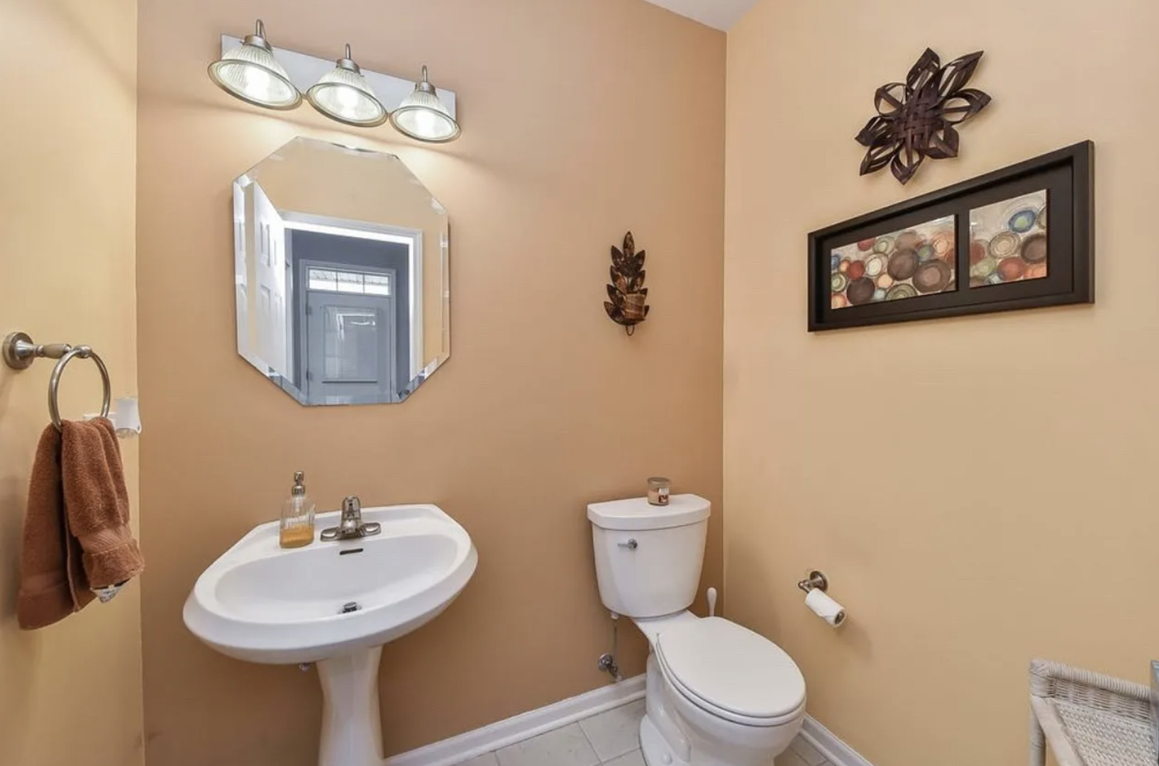 2221 Sunrise Circle, Unit 2221 Aurora, IL 60503 - Photo 9 of 15 a bathroom with a toilet sink and mirror