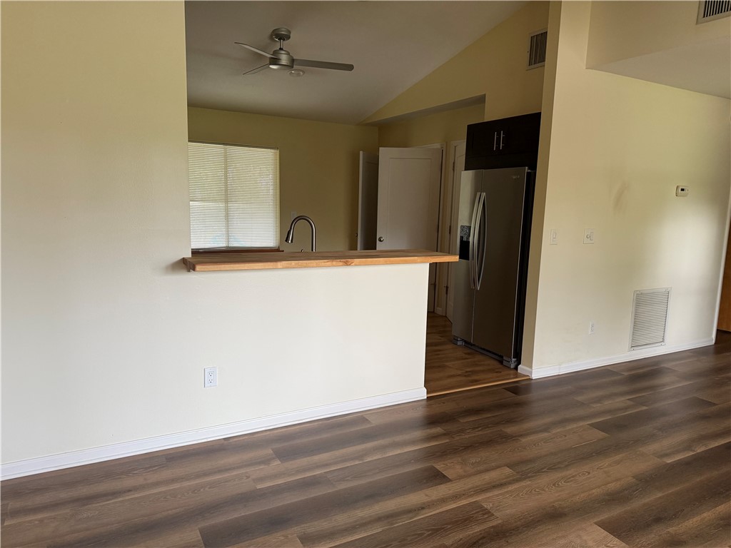 608 Stevenson Avenue Sebastian, FL 32958 - Photo 12 of 22 a view of a kitchen with wooden floor and a refrigerator