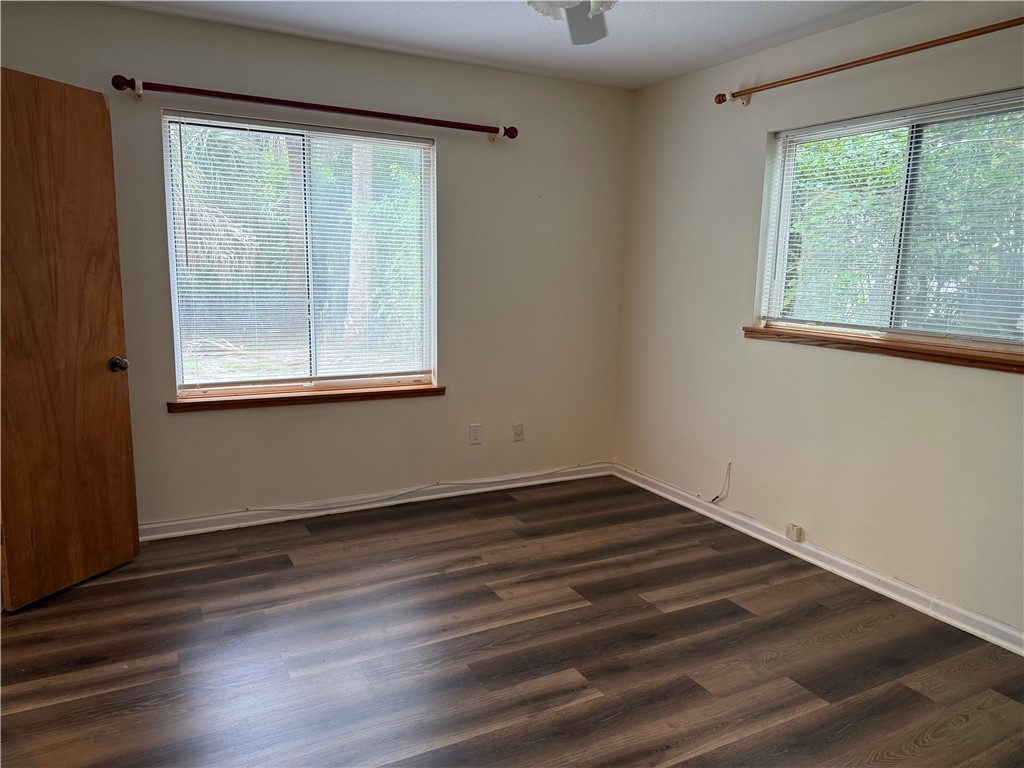 608 Stevenson Avenue Sebastian, FL 32958 - Photo 19 of 22 an empty room with wooden floor and windows